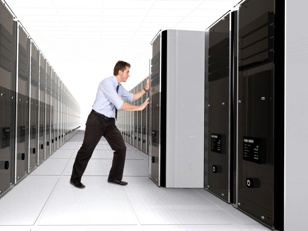 Business man adding server to network in a server room