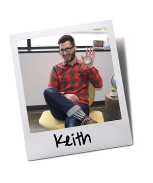 Employee holding Baudville wooden holiday ornament