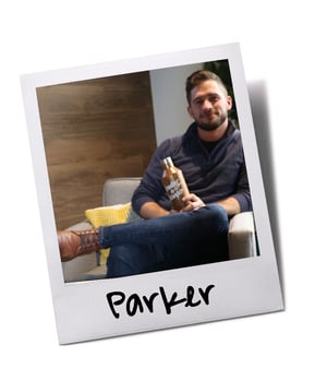 Employee holding Baudville wooden canteen tumbler